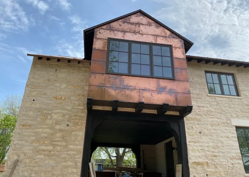 Copper metal panel facade on a stone building for Roof Repair in Bonne Terre